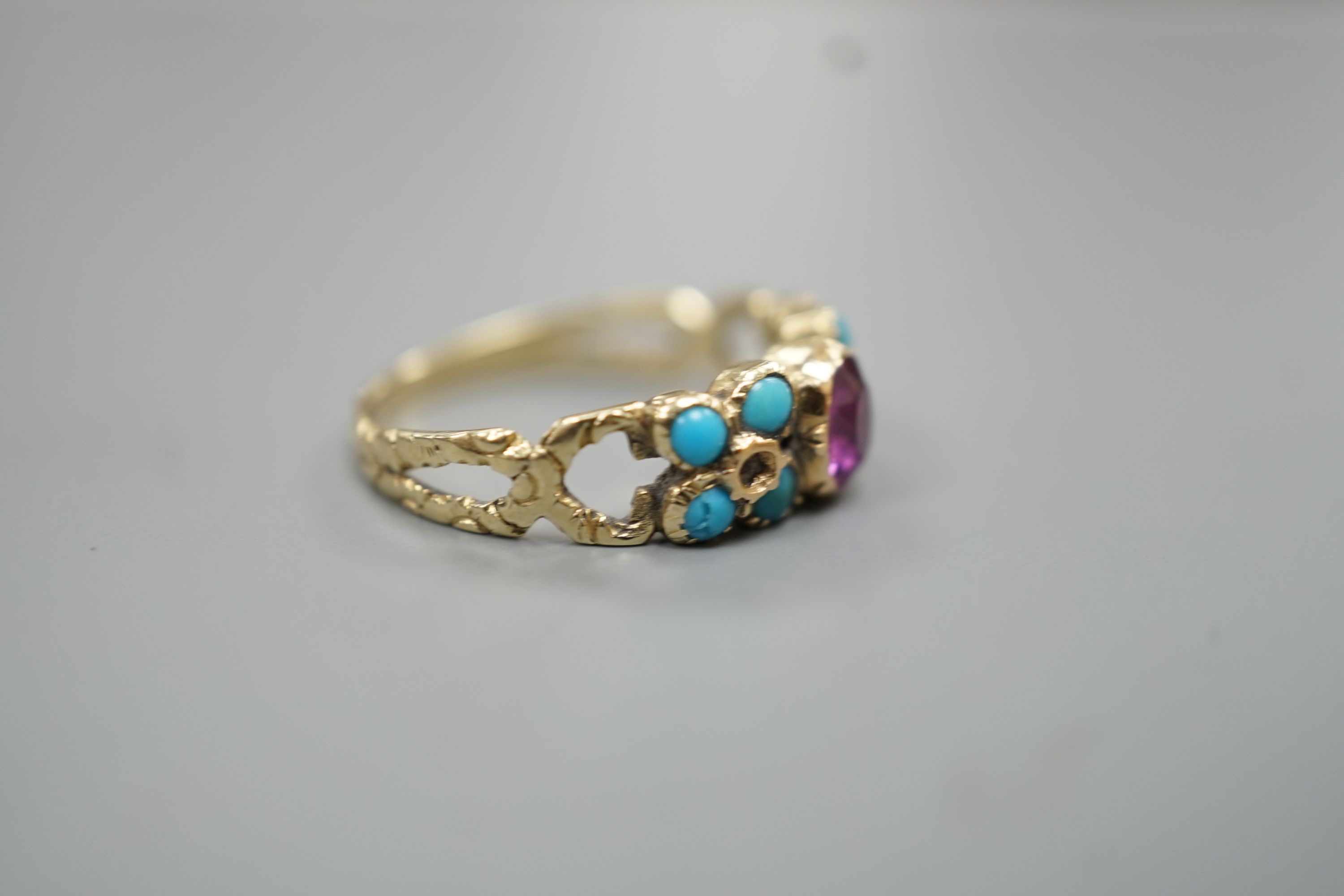 A Victorian yellow metal, turquoise and garnet set cluster ring, size M/N, gross weight, 3 grams.